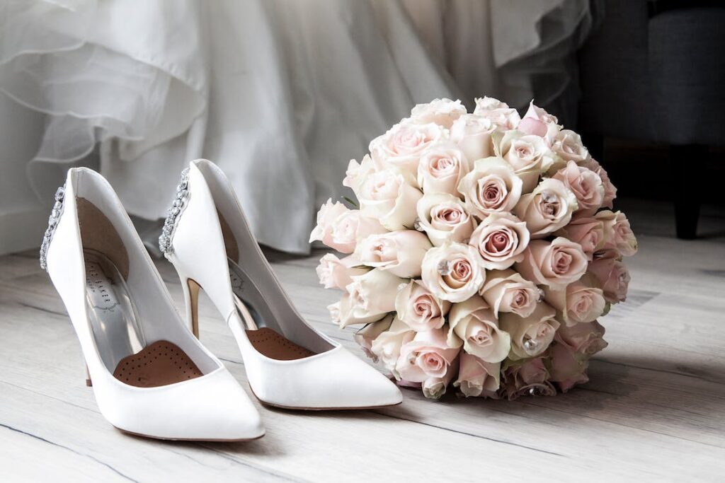 wedding shoes next to flowers 